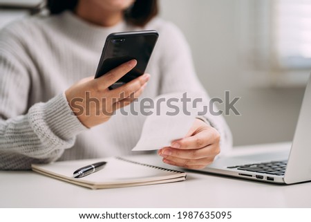 close up view of young women using smartphone scan barcode on bills payment online via app mobile, lifestyle modern female concept. Royalty-Free Stock Photo #1987635095