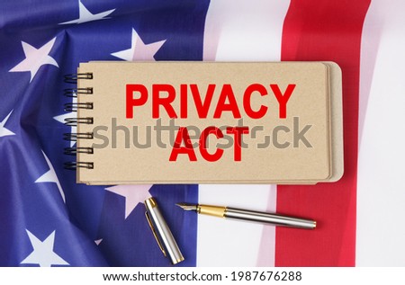 Law and order concept. Against the background of the flag of the United States of America lies a notebook with the inscription - PRIVACY ACT