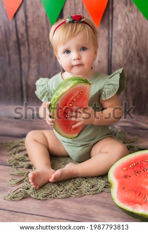child with watermelon. little girl with blond hair eats watermelon. 