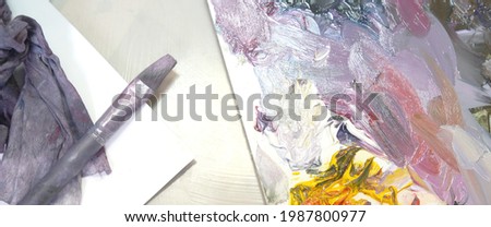 A palette with multi-colored paint and brushes for drawing. High quality banner