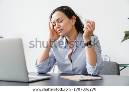Headache. Tired depressed stressed mature businesswoman suffering from migraine allergy at work. Sad ill sick middle-aged woman having overwork or menopause at home office. Respiratory illness. Royalty-Free Stock Photo #1987806290
