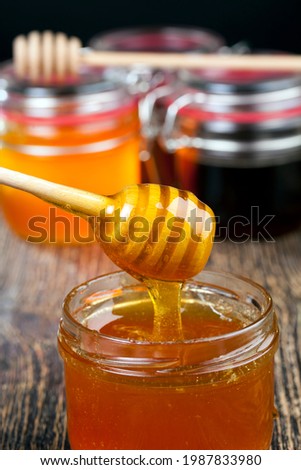 dipped in honey specially made from wood homemade coarse spoon, sweet bee honey and wooden spoon that allows you to transfer and pour honey without dripping and spreading