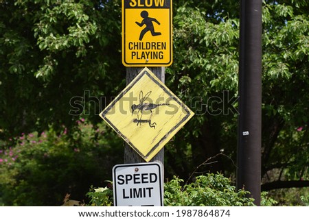 The road sign make fun of crane fly that look like big mosquito and big enough to lift children up