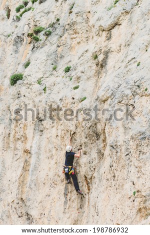 Young man climbing on a wall 