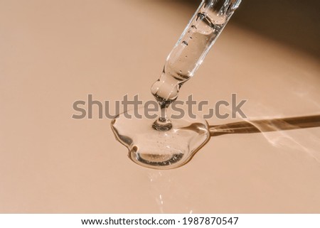A drop of cosmetic oil falls from the pipette Royalty-Free Stock Photo #1987870547