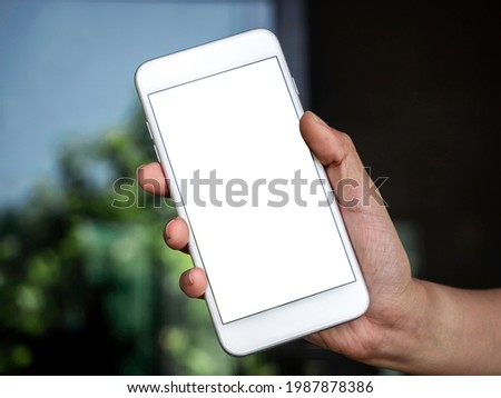 Mockup image of phone. Close-up white blank screen on mobile phone in hand. Hand holding white smartphone with empty screen.
