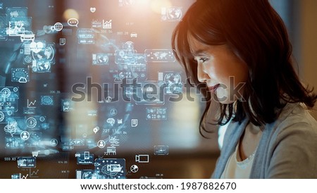 Asian woman watching hologram screens. Business and technology concept. Smart office. GUI (Graphical User Interface). Royalty-Free Stock Photo #1987882670