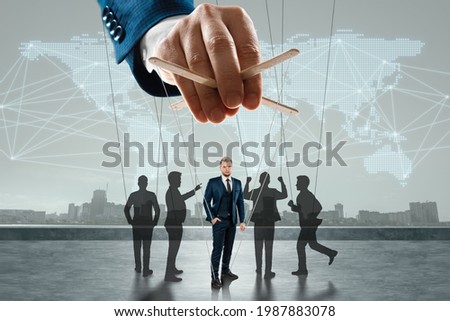 Male hand, puppeteer controls the crowd with threads, society. The concept of world conspiracy, world government, manipulation, control Royalty-Free Stock Photo #1987883078