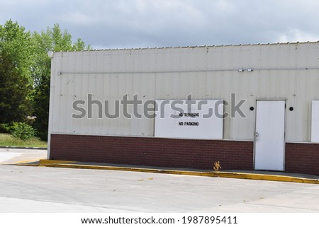 Abandoned industrial building with a parking lot