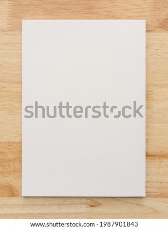 White paper texture on wood background. Close-up.