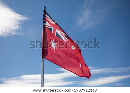 A red and white flag blowing in the wind