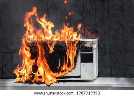 Microwave oven burns, house fire due to improper operation, spontaneous combustion of faulty appliances Royalty-Free Stock Photo #1987919393