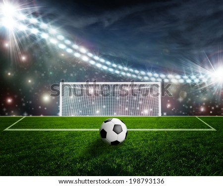 Soccer ball on green stadium arena