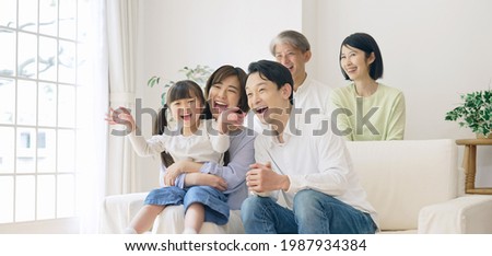 Asian girl and parents and Grandparents in the house. Three generation family. Royalty-Free Stock Photo #1987934384
