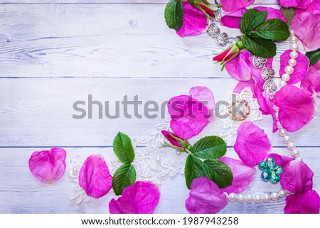 Romantic background. On a white sheet rose petals, decorations and candles close-up.