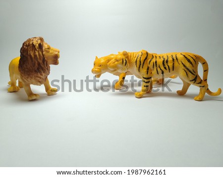 Lion and tiger plastic toy - miniature plastic toy animals on white background