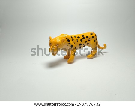 Cheetah plastic toy - miniature plastic toy animals on white background