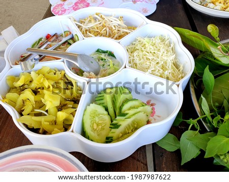 Mixed vegetables tray both fresh and pickle to go with Thai popular curry soup noodle called "Khanom jeen".