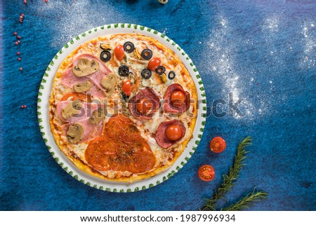 assorted pizza top view, turquoise background