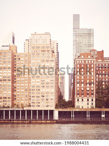 Residential buildings along East River waterfront, retro color toned picture, New York City, USA.