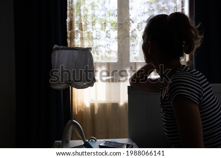 silhouette of woman by bedside holding her head mental health