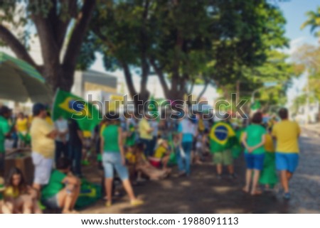 Protest Blurred photo meeting people march against corruption with flags brazil. Blurred background concept image.
