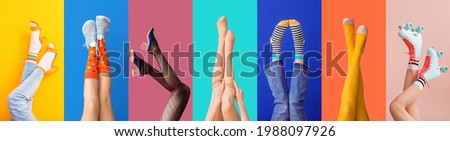 Legs of stylish young women on color background Royalty-Free Stock Photo #1988097926