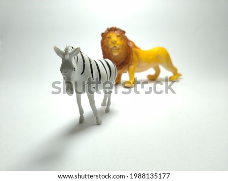 Zebra and Lion plastic toy, Lion looking for the zebra - Miniature plastic toy animals 