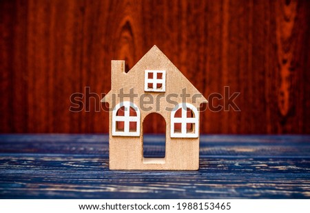 House symbol on a brown wooden background
