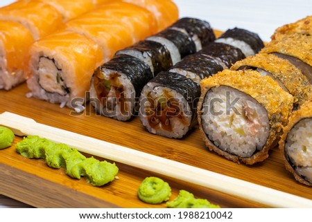 Philadelphia roll sushi with salmon, shrimps, avocado, cream cheese. Sushi menu. Japanese food.
Sushi roll isolated on white close up
