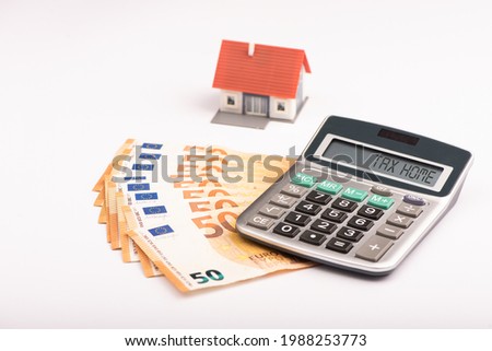 Calculator, euro money and model house. Tax home concept