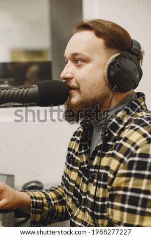 Radio host speaking through a microphone