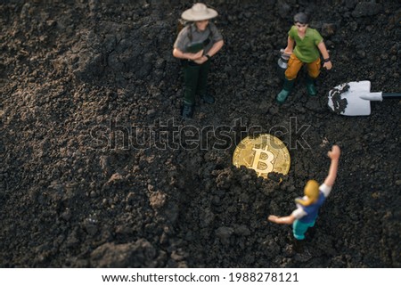 Macro miner figurines digging ground to uncover big shiny bitcoin. Cryptocurrency near mountain. Digital Investment and Discovery Ideas