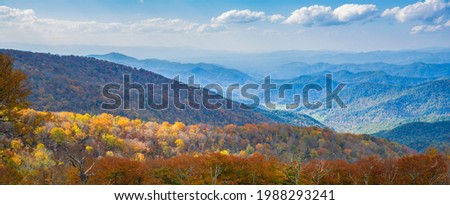 Beautiful autumn mountain panorama. A panoramic view of the Blue Ridge Mountains from the Blue Ridge Parkway. Near Asheville, North Carolina, USA. Image for banner or web header.