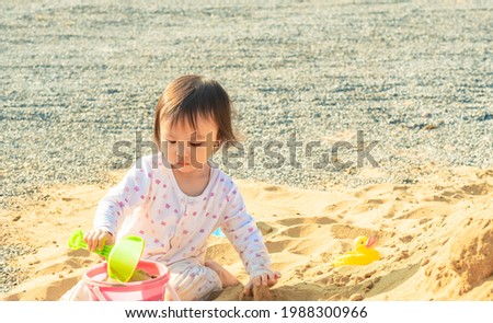 Asian child girl playing toy and sand with natural background. Copy space.