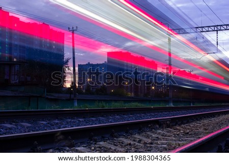 A passing train left traces of headlights Photo taken on the tracks in Moscow, electric train, light, city, spring, ball, 2021. Royalty-Free Stock Photo #1988304365