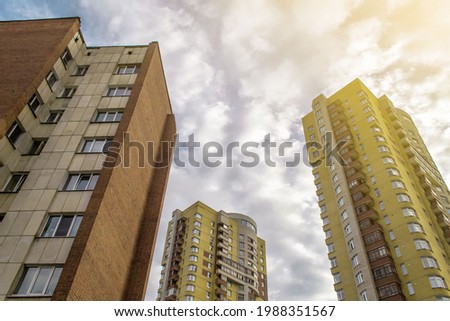 High-rise buildings against the sky and sunset. Sunlight from the side of the photo.