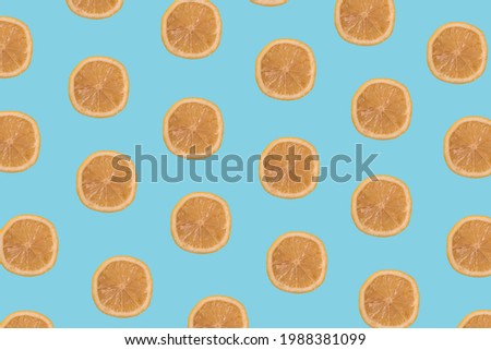 Lemon slices multiplied on trendy pastel soft blue background. Minimal 
healthy food, tropical fruits and summer concept.