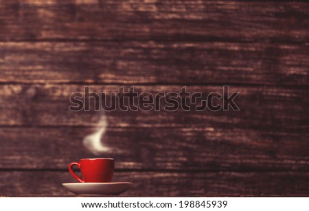 Tea or coffee cup on wooden table.
