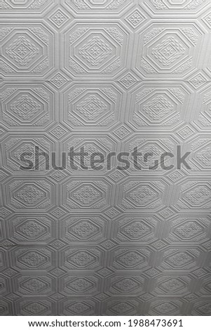 Textured white wallpaper in the form of squares as a background.