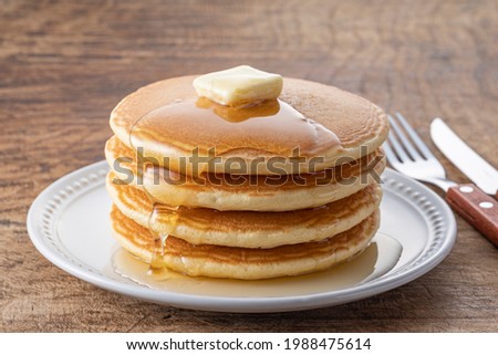 Pancakes on a wooden table Royalty-Free Stock Photo #1988475614