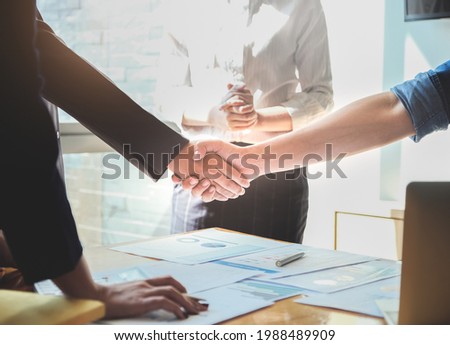 Two businessmen shake hands after a final project agreement is completed to strengthen the business between the two companies