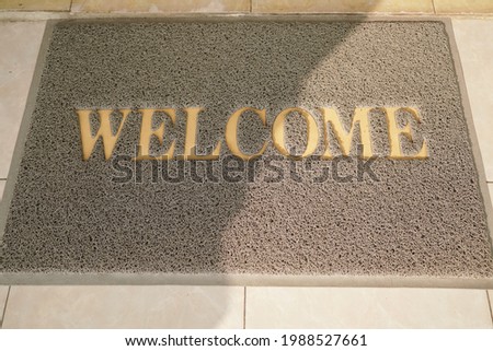 A doormat with a welcome sign on it was outside an office door