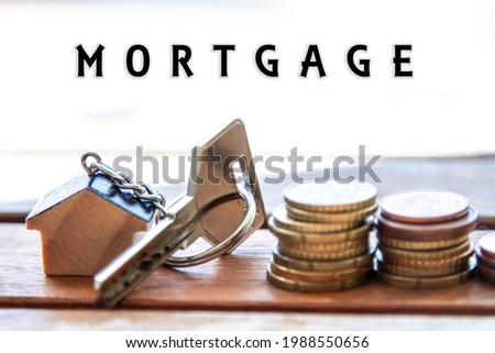 house keychain and key with documents and coins, finance, real estate and mortgage concept