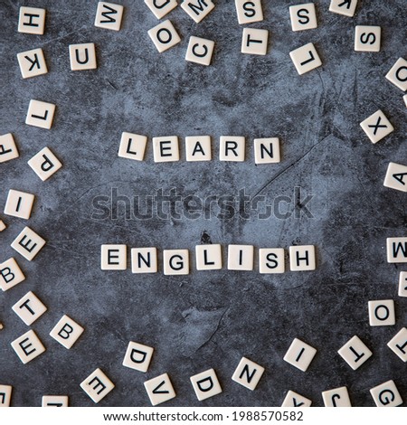 learn english word written on grey marble background with frame of scattered letters. learn english text on table, concept. Square instagram format. Royalty-Free Stock Photo #1988570582
