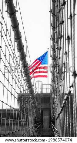 American flag on the top of Brooklyn Bridge, color toning applied, New York City, USA.