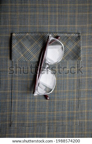 Glasses for correcting vision, effectively lie on the office fabric of olive color. Pocket.