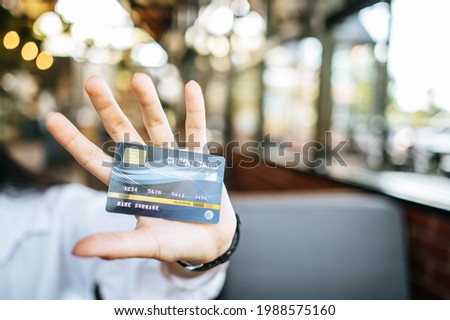 woman holding credit card in restaurant