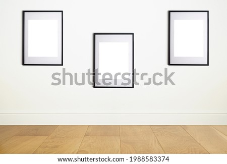 Mock up poster frame in interior white wall. White frame for poster or photo image on clean wall in home room or office interior