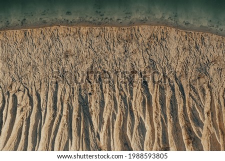 Aerial view of Sand Dunes and Stone Hills. Extraction of limestone for construction. Bornitsky quarry near an artificial lake. Dunes of the Cote d'Azur Royalty-Free Stock Photo #1988593805